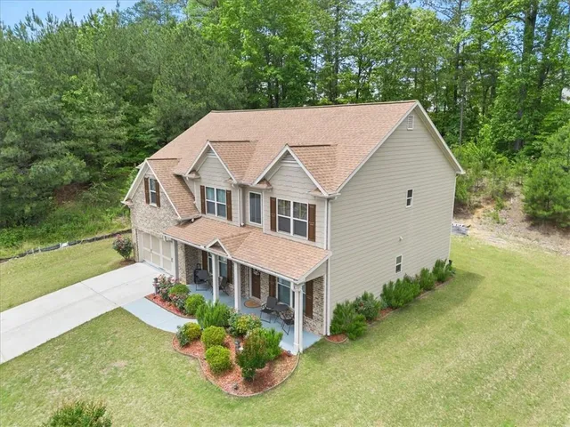 a aerial view of a house with yard and lake view