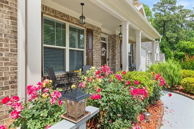 a flower garden is sitting in front of a house