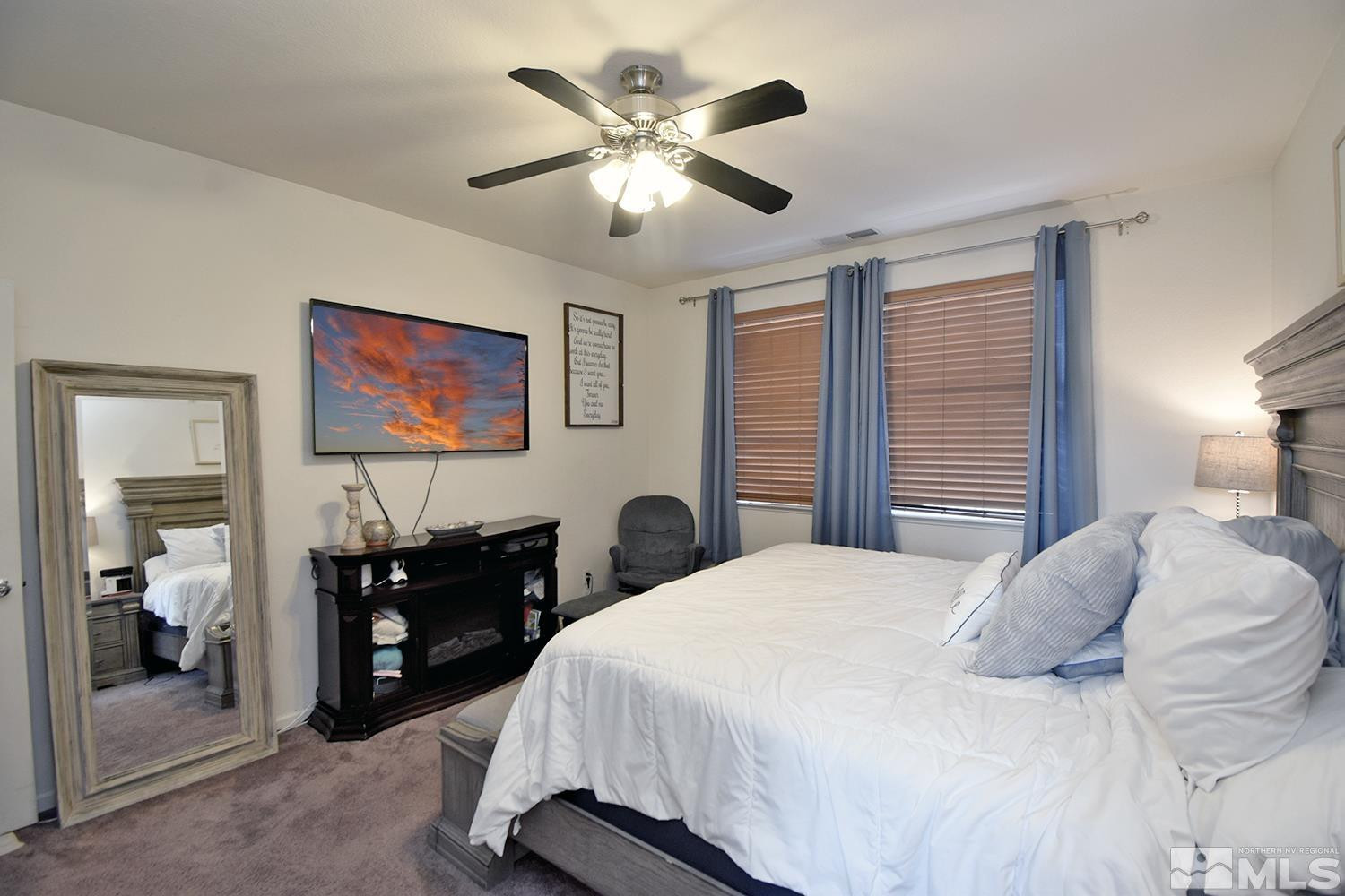 9335 Hummer Court Reno, NV 89521 - Photo 11 of 24 a bedroom with a bed and a chandelier