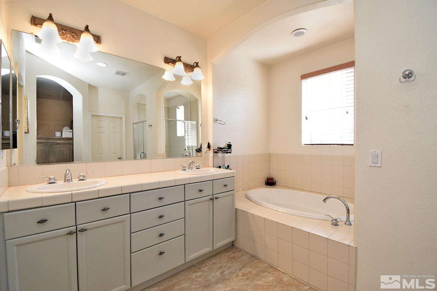 9335 Hummer Court Reno, NV 89521 - Photo 12 of 24 a bathroom with a granite countertop sink mirror and bathtub