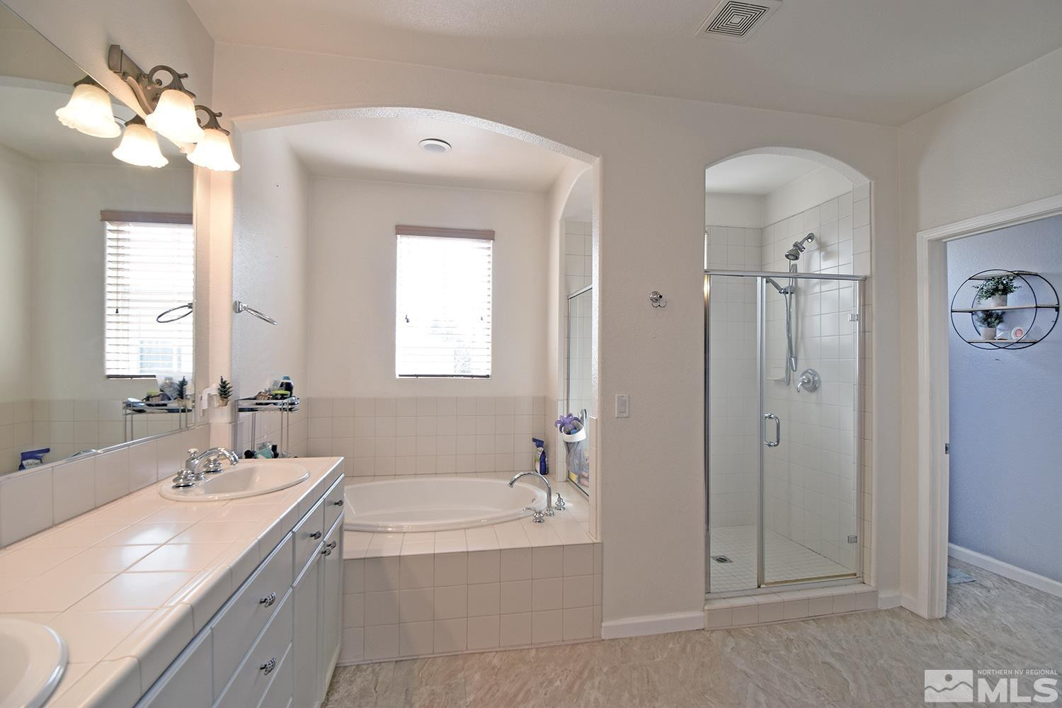 9335 Hummer Court Reno, NV 89521 - Photo 13 of 24 a spacious bathroom with 2 sink tub and a mirror