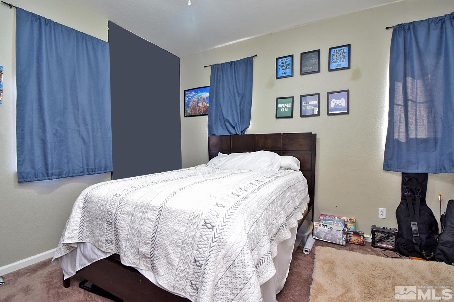 9335 Hummer Court Reno, NV 89521 - Photo 15 of 24 a bedroom with a bed and a lamp