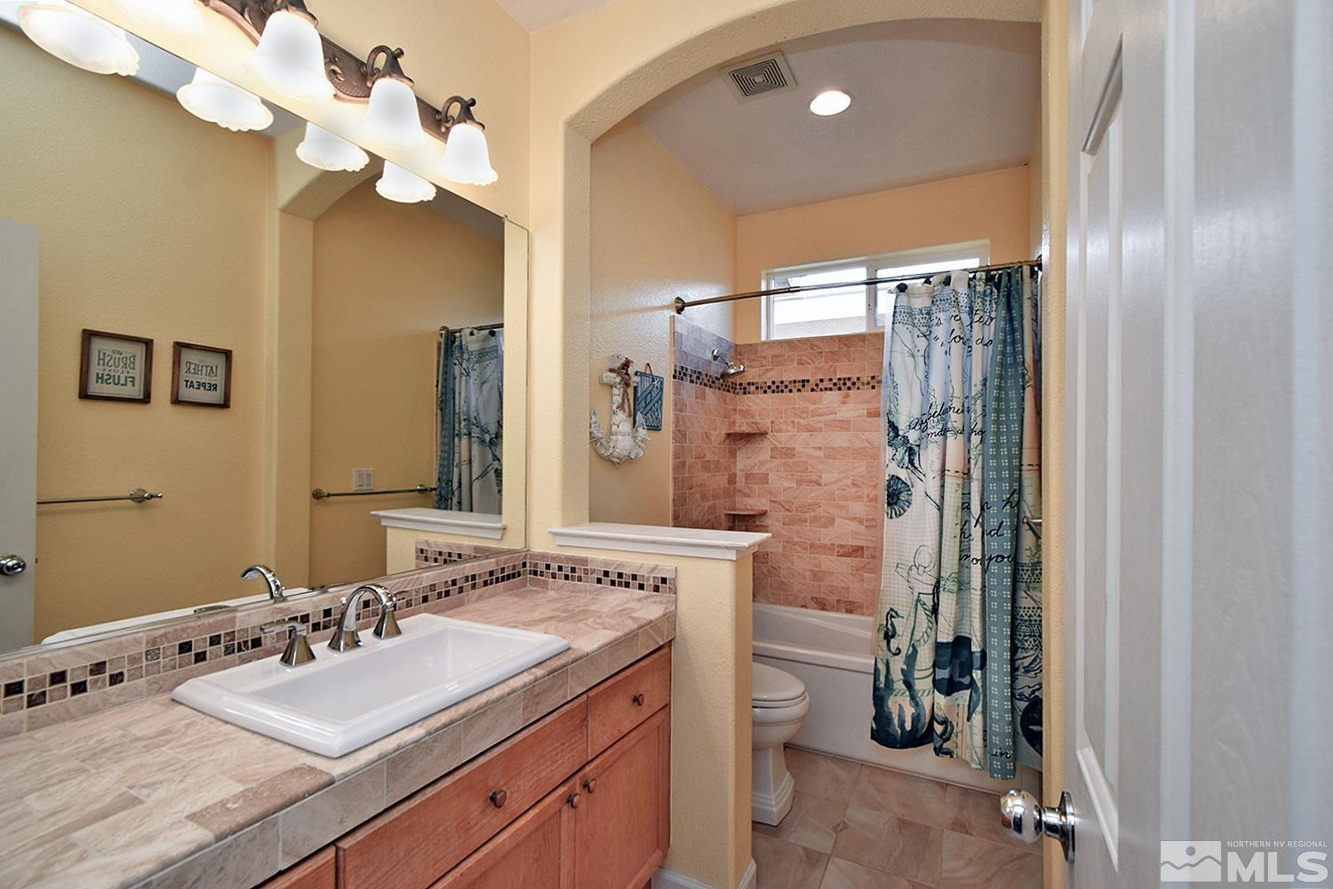 9335 Hummer Court Reno, NV 89521 - Photo 16 of 24 a bathroom with a sink vanity granite and a mirror