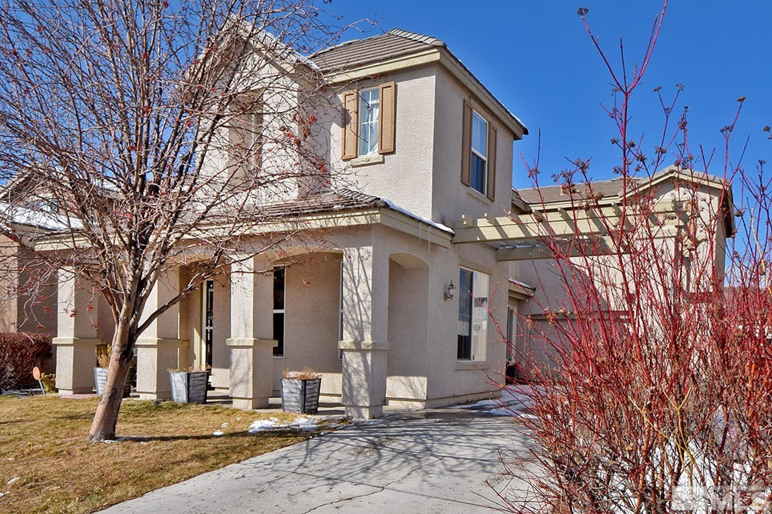 9335 Hummer Court Reno, NV 89521 - Photo 24 of 24 a view of a white house with large windows and a tree