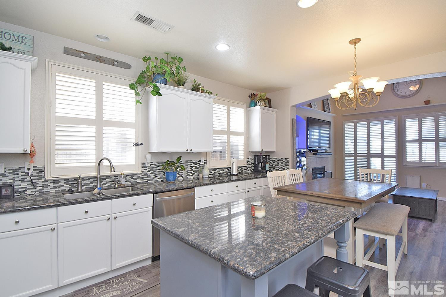 9335 Hummer Court Reno, NV 89521 - Photo 3 of 24 a kitchen with center island table and chairs in it