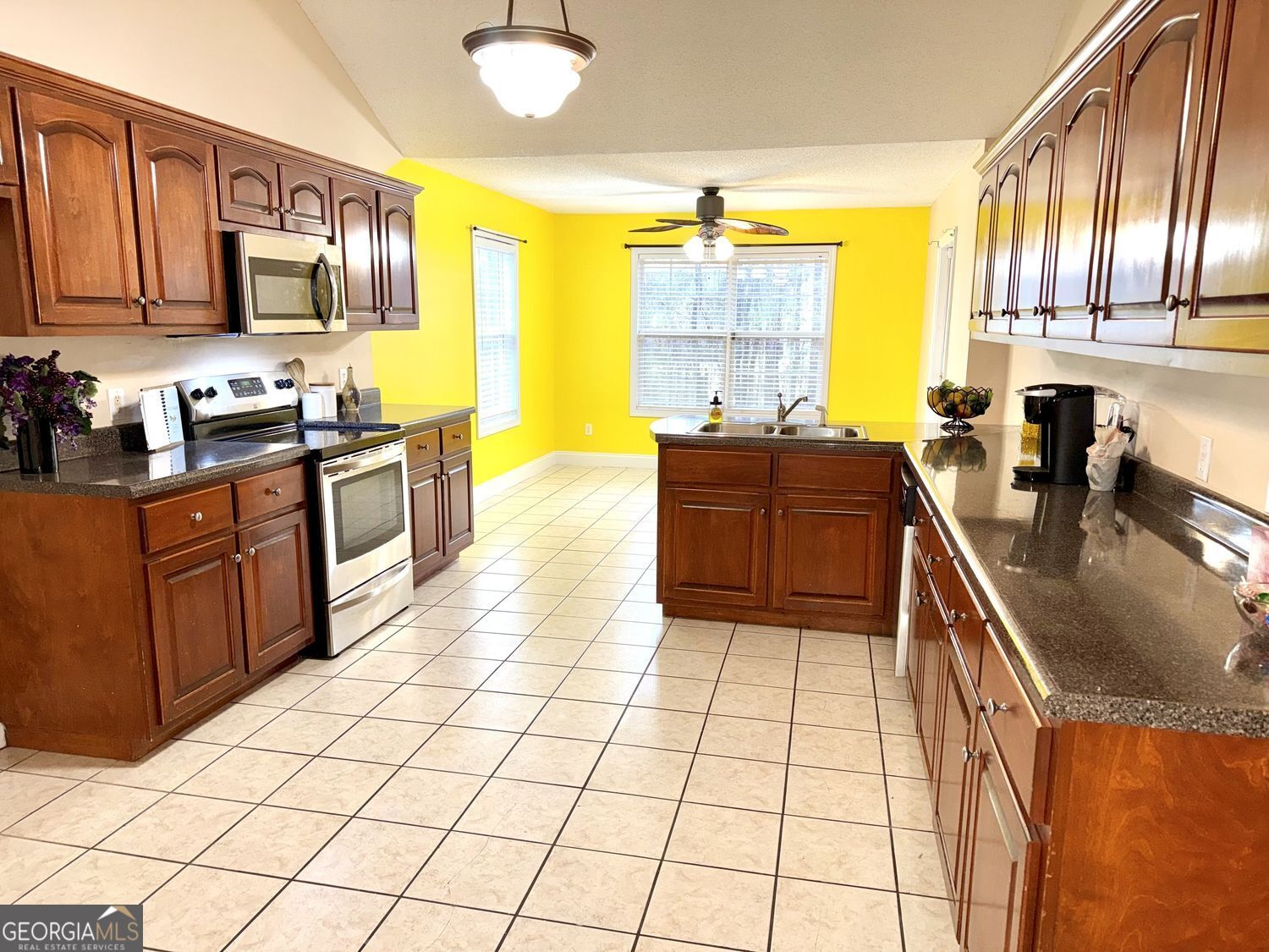 229 Lite-N-Tie Road Gray, GA 31032 - Photo 13 of 21 a kitchen with stainless steel appliances granite countertop a stove a sink and a microwave