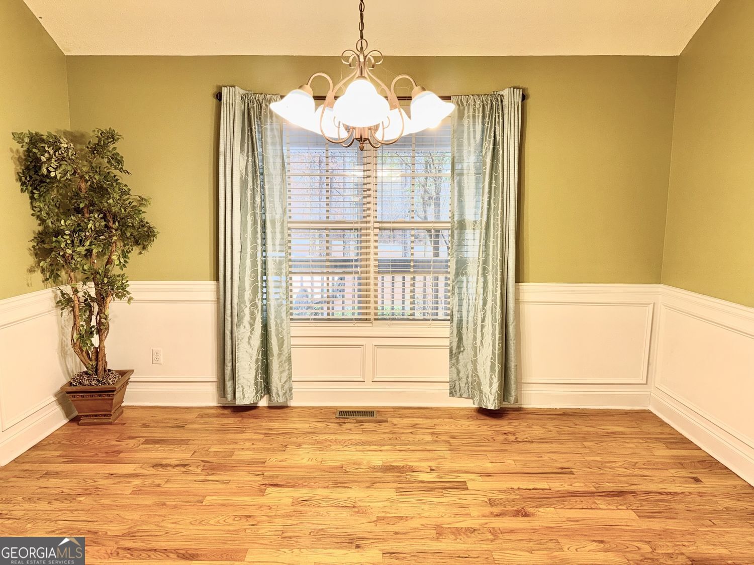 229 Lite-N-Tie Road Gray, GA 31032 - Photo 6 of 21 a view of a livingroom with wooden floor and a chandelier