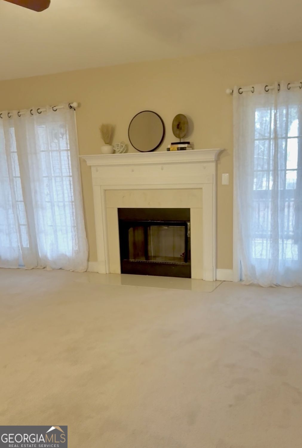 229 Lite-N-Tie Road Gray, GA 31032 - Photo 7 of 21 a view of an empty room with chandelier and fireplace
