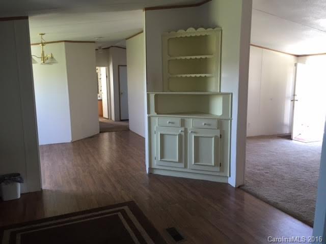 4365 Tite Road Stanfield, NC 28163 - Photo 11 of 22 an empty room with wooden floor and windows