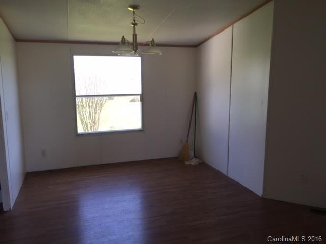 4365 Tite Road Stanfield, NC 28163 - Photo 13 of 22 an empty room with wooden floor and windows
