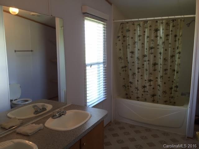 4365 Tite Road Stanfield, NC 28163 - Photo 16 of 22 a bathroom with a sink and a mirror