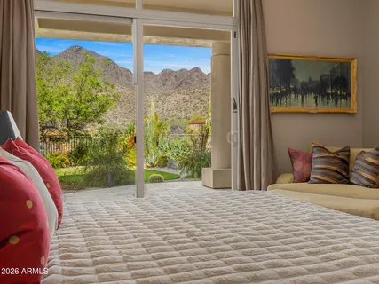 a bedroom with a bed and a view of balcony