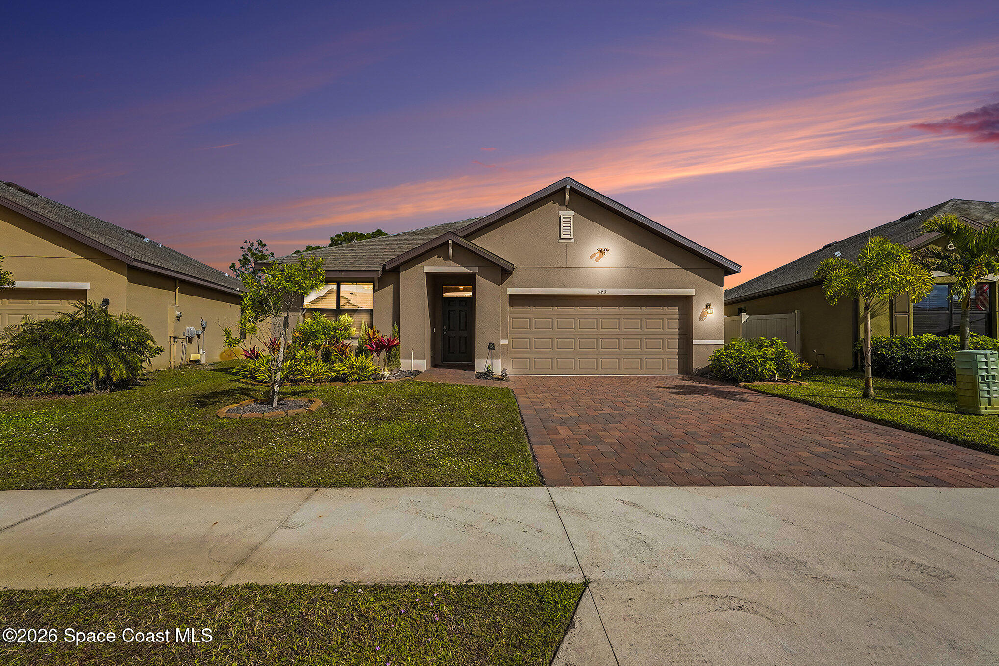 543 Old Country Rd S East Palm Bay, FL 32909 - Photo 1 of 21 a front view of a house with a yard and garage