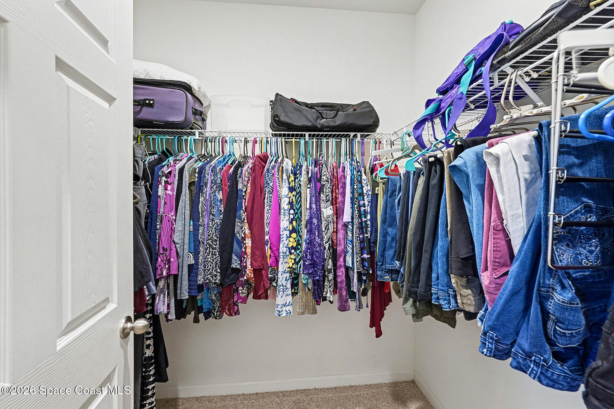 543 Old Country Rd S East Palm Bay, FL 32909 - Photo 11 of 21 a view of walk in closet with clothes
