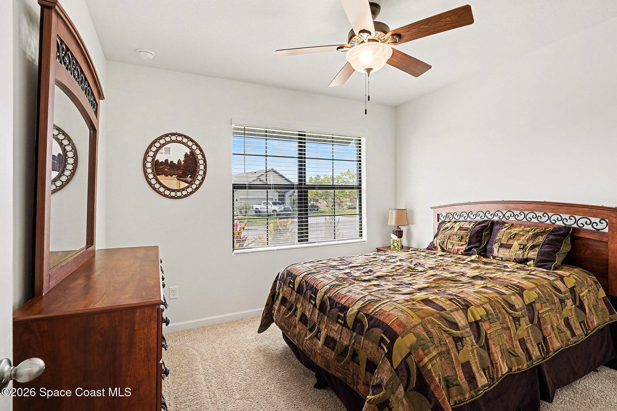 543 Old Country Rd S East Palm Bay, FL 32909 - Photo 14 of 21 a large bed sitting in a bedroom next to a window