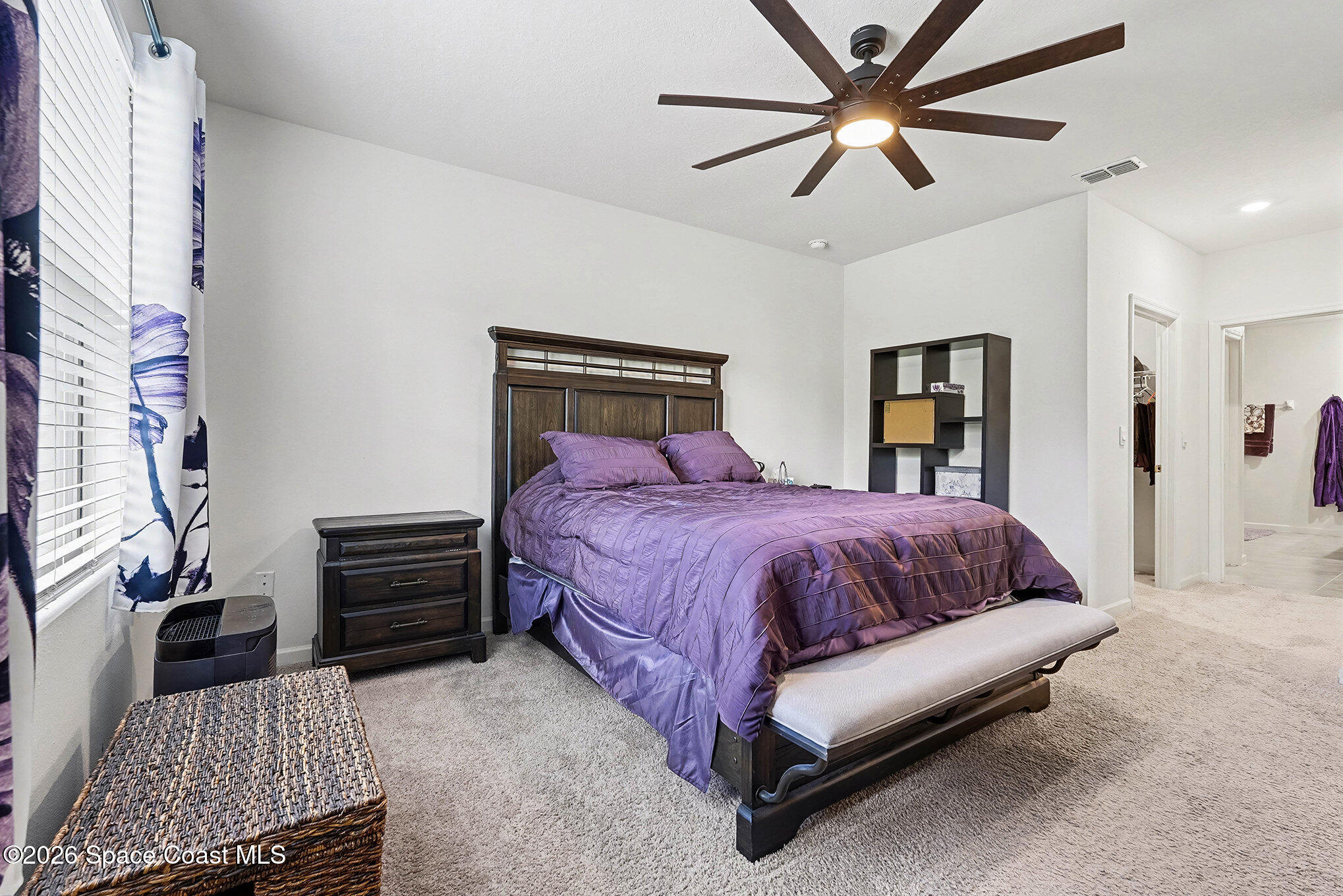 543 Old Country Rd S East Palm Bay, FL 32909 - Photo 9 of 21 a spacious bedroom with a bed and a chandelier