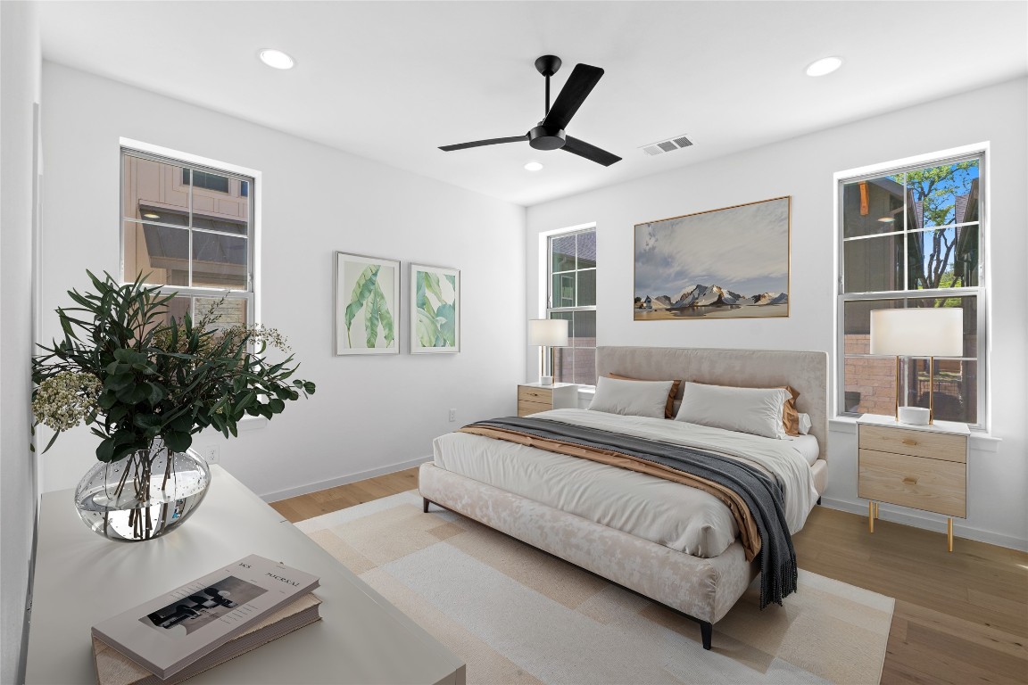 3500 Pecan Springs Road, Unit 16 Austin, TX 78723 - Photo 7 of 18 a bedroom with a large bed and a chandelier