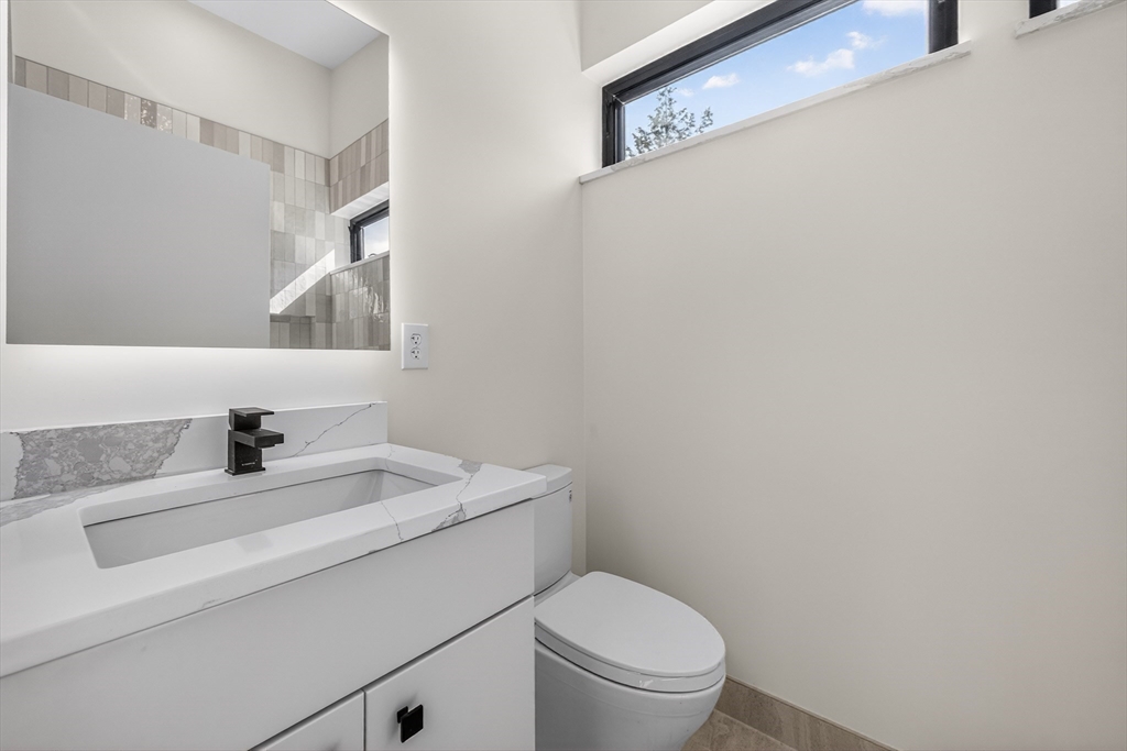 15 Bird Hill Road Lexington, MA 02421 - Photo 28 of 34 a bathroom with a sink toilet and a mirror