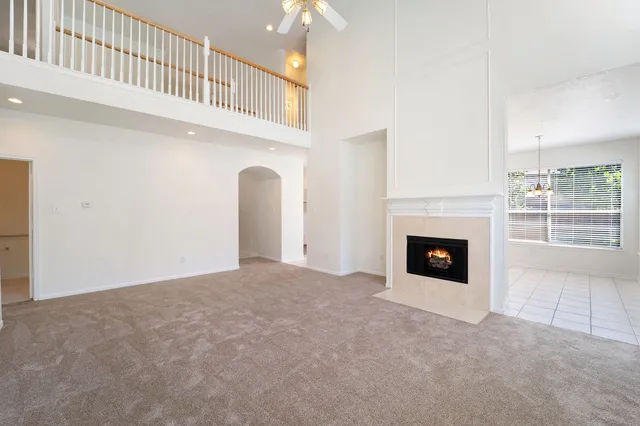 a view of an empty room with a fireplace