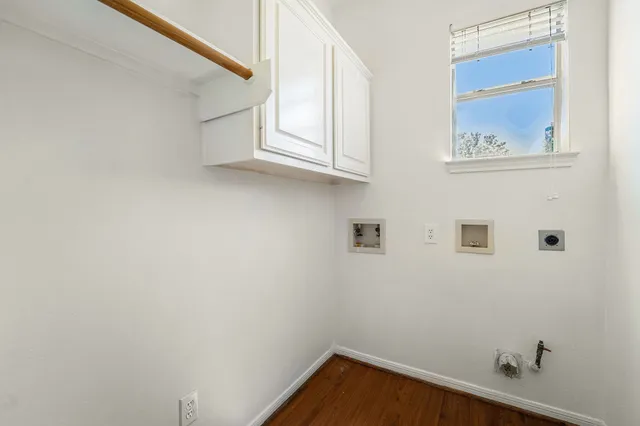 a view of small space with wooden floor and windows