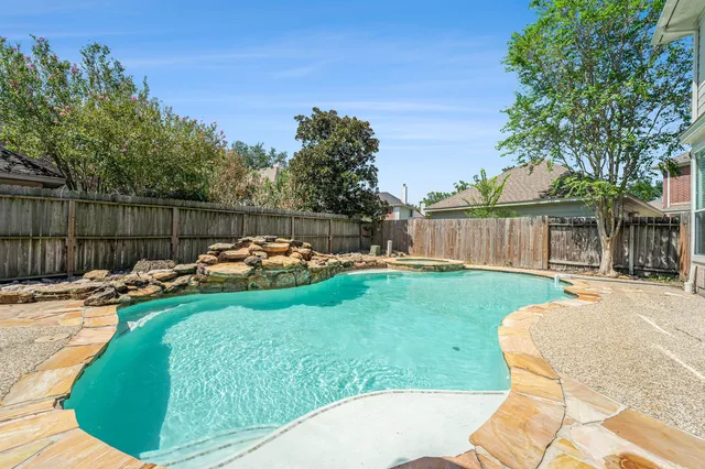 a view of a backyard with a garden and fire pit