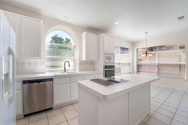 a kitchen with a sink cabinets and window