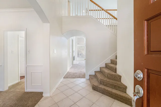 a view of entryway with stairs and a rug