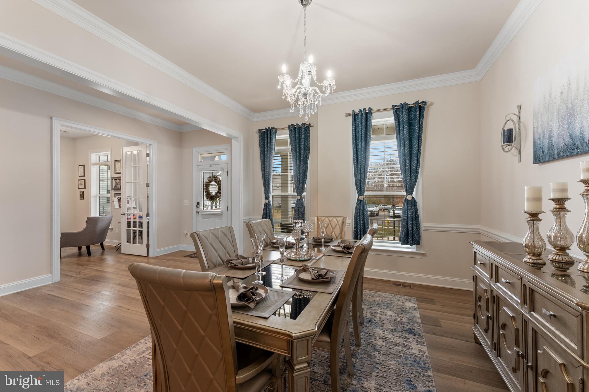 13882 Trinity Pond Lane Manassas, VA 20112 - Photo 11 of 69 a dining room with furniture a chandelier and wooden floor