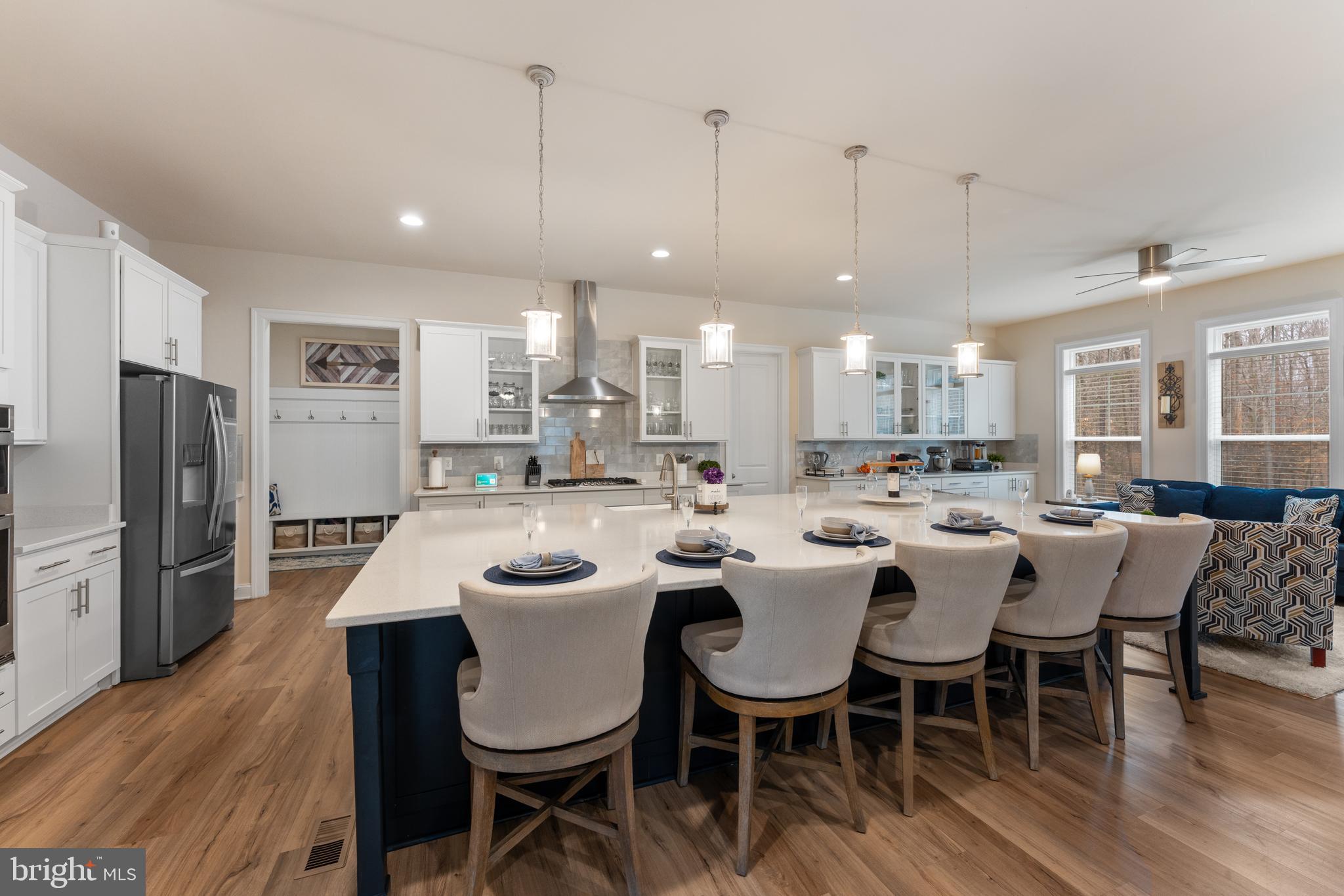 13882 Trinity Pond Lane Manassas, VA 20112 - Photo 12 of 69 a large kitchen with a table and chairs