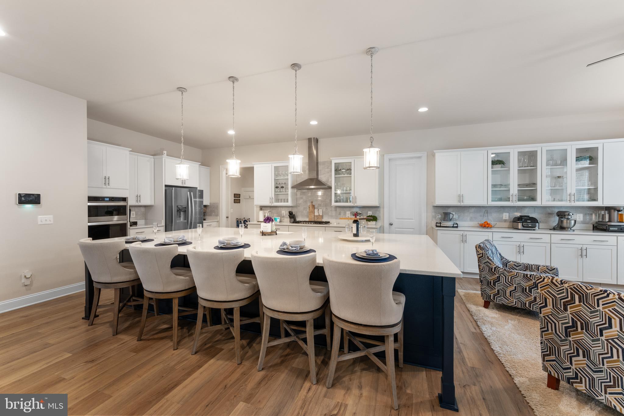 13882 Trinity Pond Lane Manassas, VA 20112 - Photo 13 of 69 a large kitchen with a table and chairs
