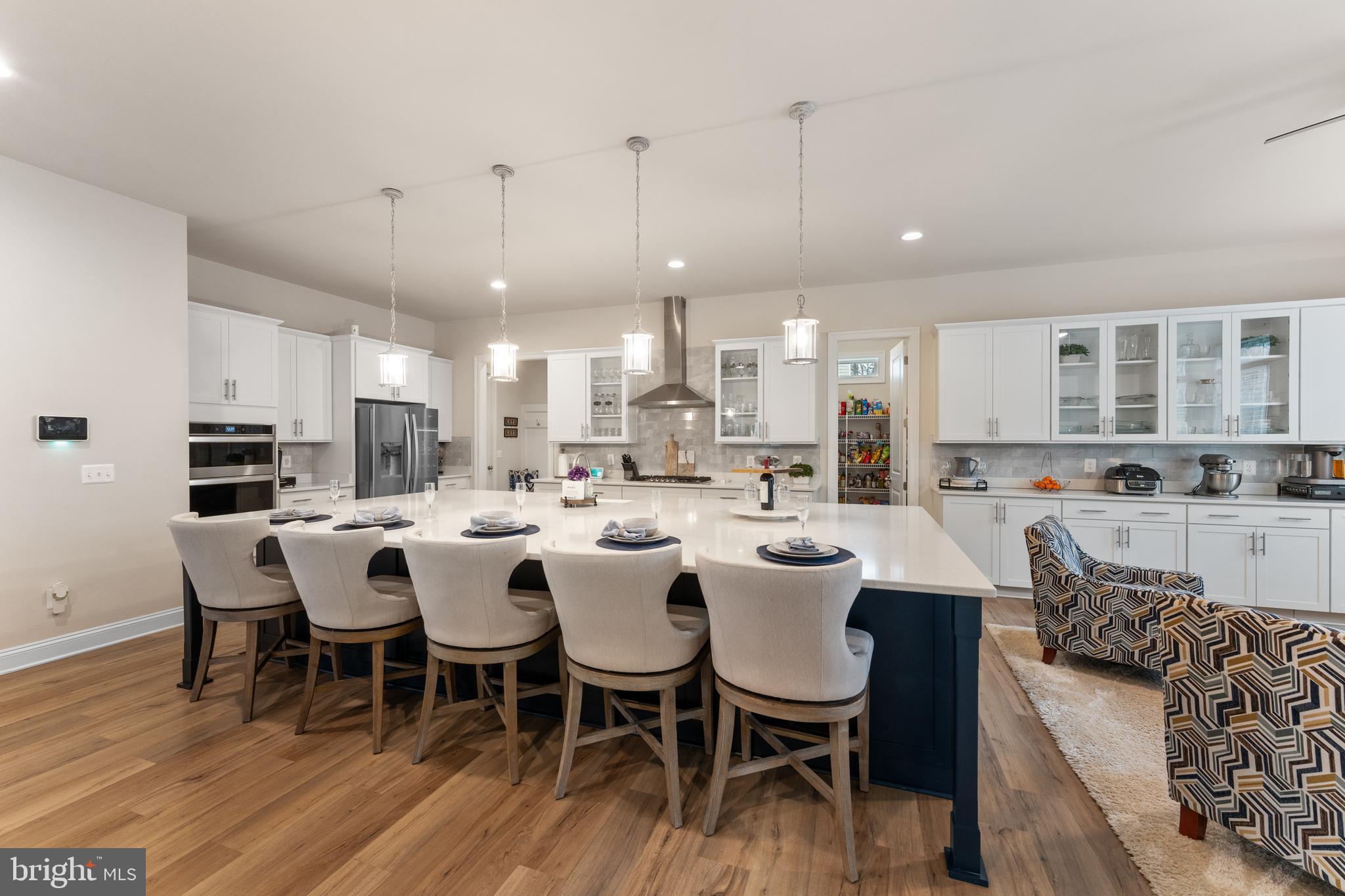 13882 Trinity Pond Lane Manassas, VA 20112 - Photo 14 of 69 a large kitchen with a table and chairs