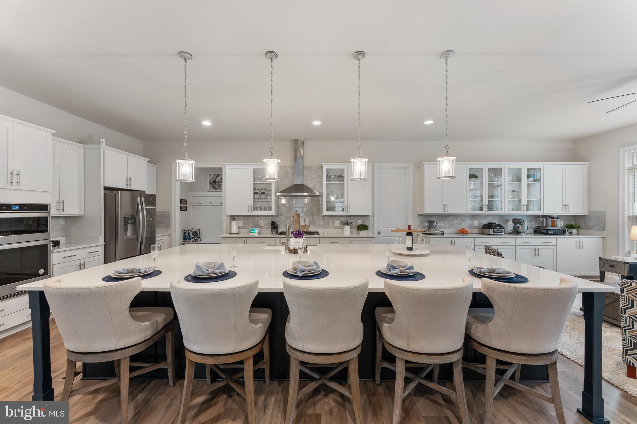 13882 Trinity Pond Lane Manassas, VA 20112 - Photo 17 of 69 a kitchen with a dining table chairs sink and microwave