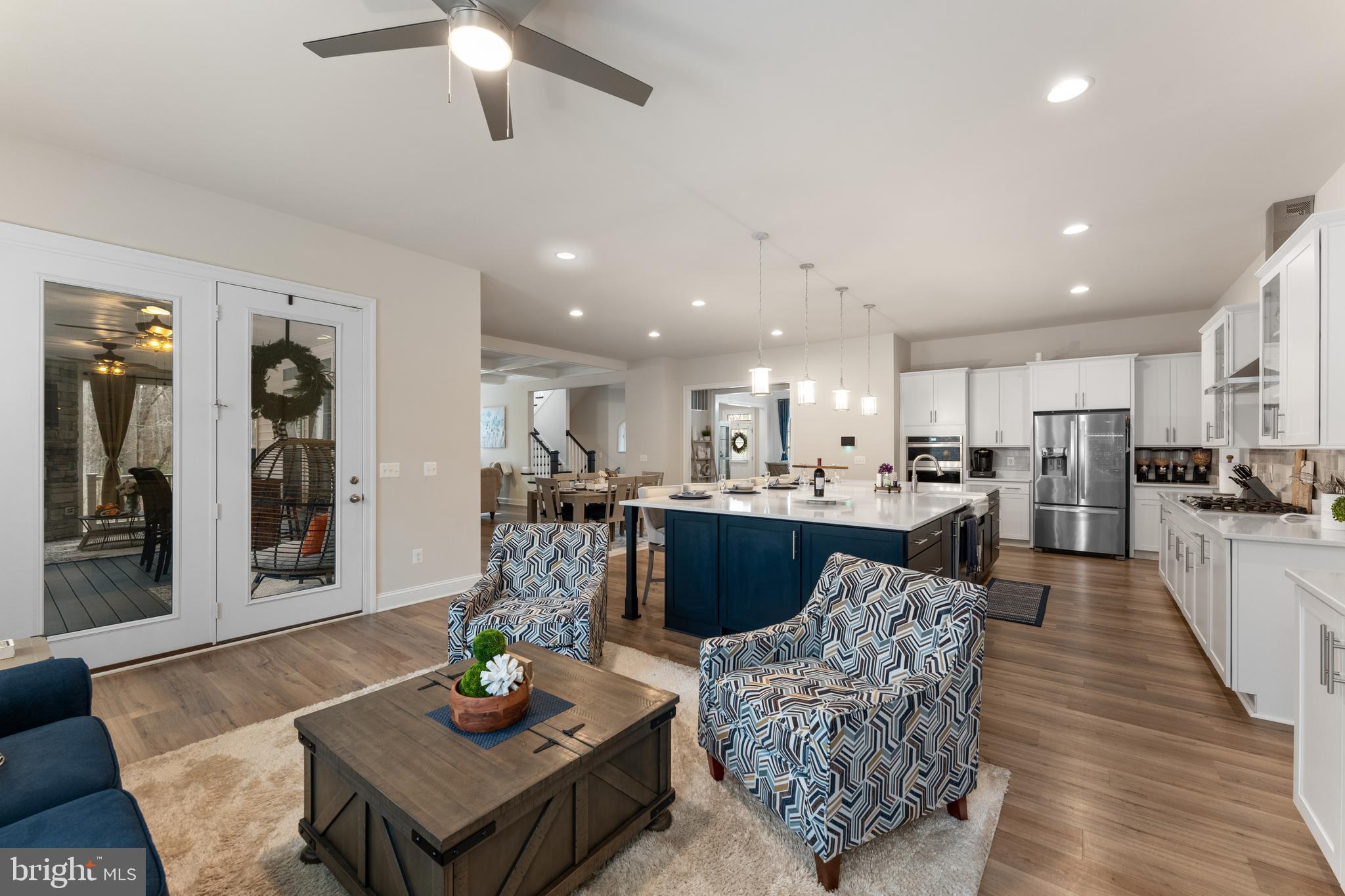 13882 Trinity Pond Lane Manassas, VA 20112 - Photo 19 of 69 a living room with furniture kitchen view and a wooden floor