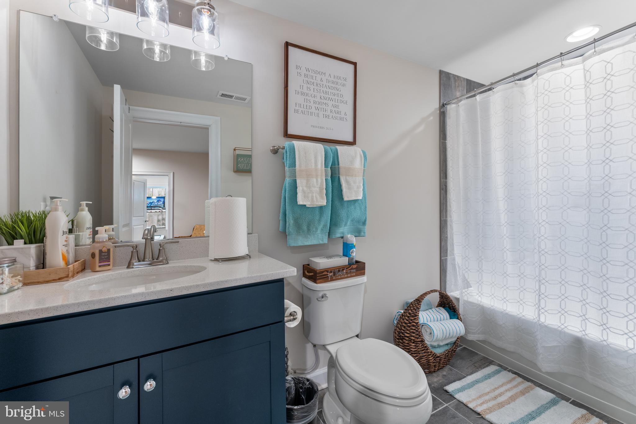 13882 Trinity Pond Lane Manassas, VA 20112 - Photo 29 of 69 a bathroom with a granite countertop sink toilet a mirror a vanity and shower