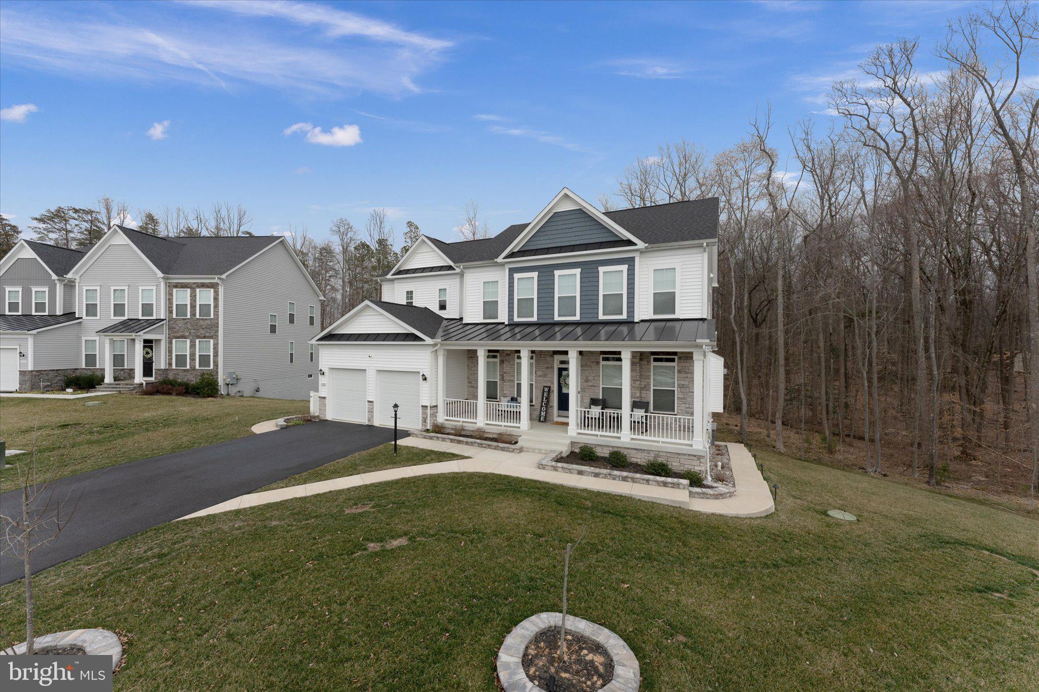 13882 Trinity Pond Lane Manassas, VA 20112 - Photo 3 of 69 a front view of a house with a yard