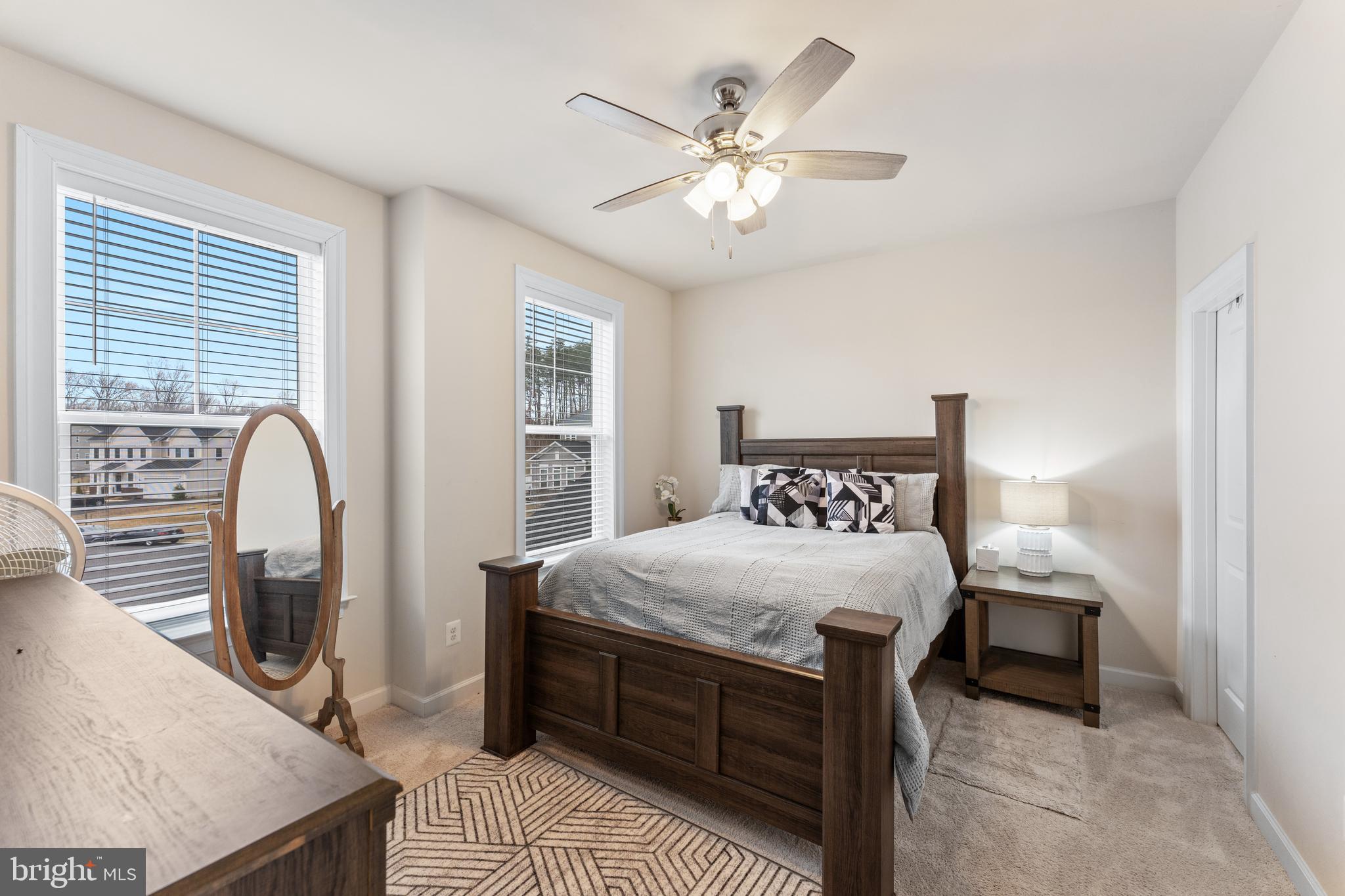 13882 Trinity Pond Lane Manassas, VA 20112 - Photo 36 of 69 a bedroom with a large bed and a chandelier