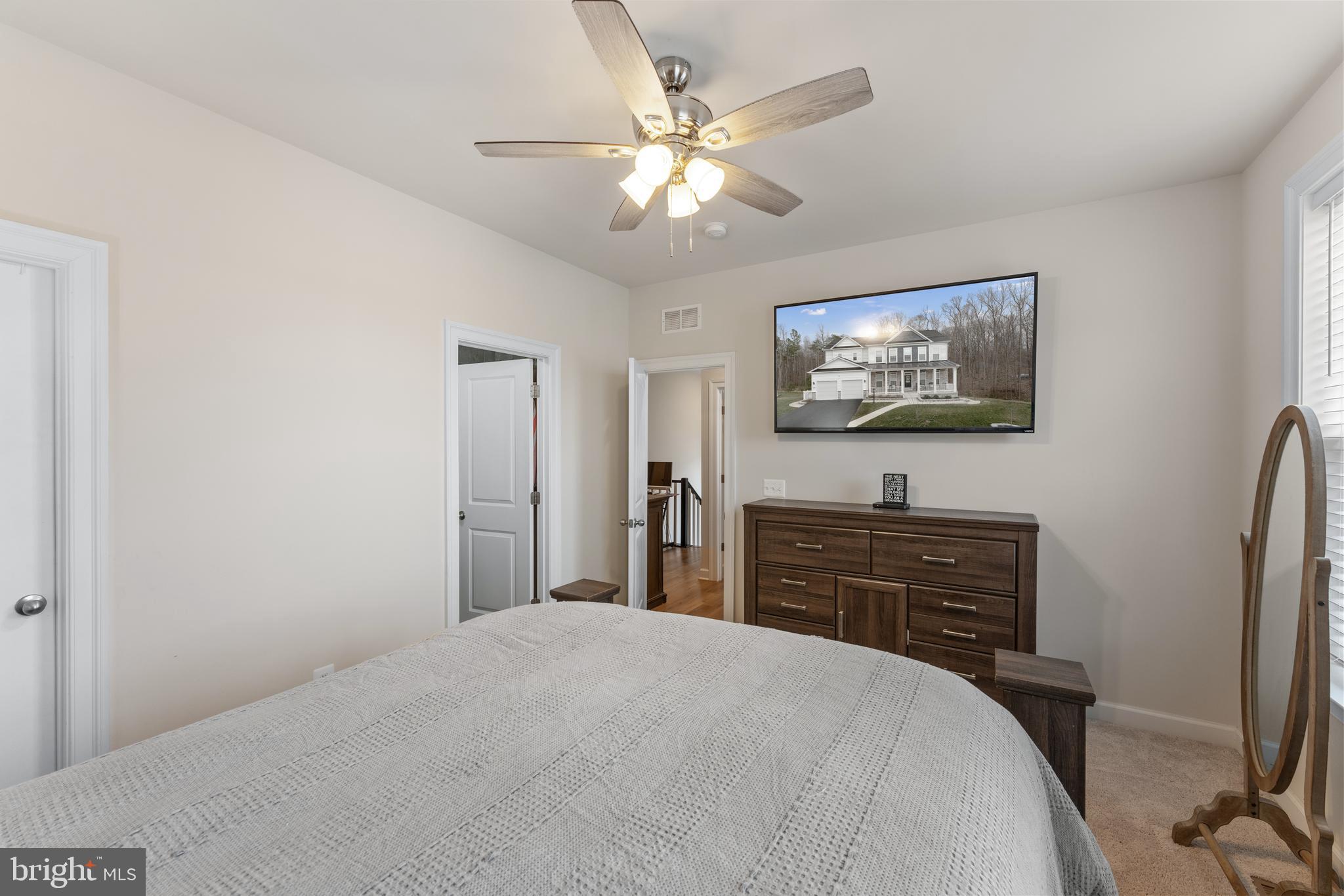 13882 Trinity Pond Lane Manassas, VA 20112 - Photo 37 of 69 a bedroom with a bed and a flat screen tv