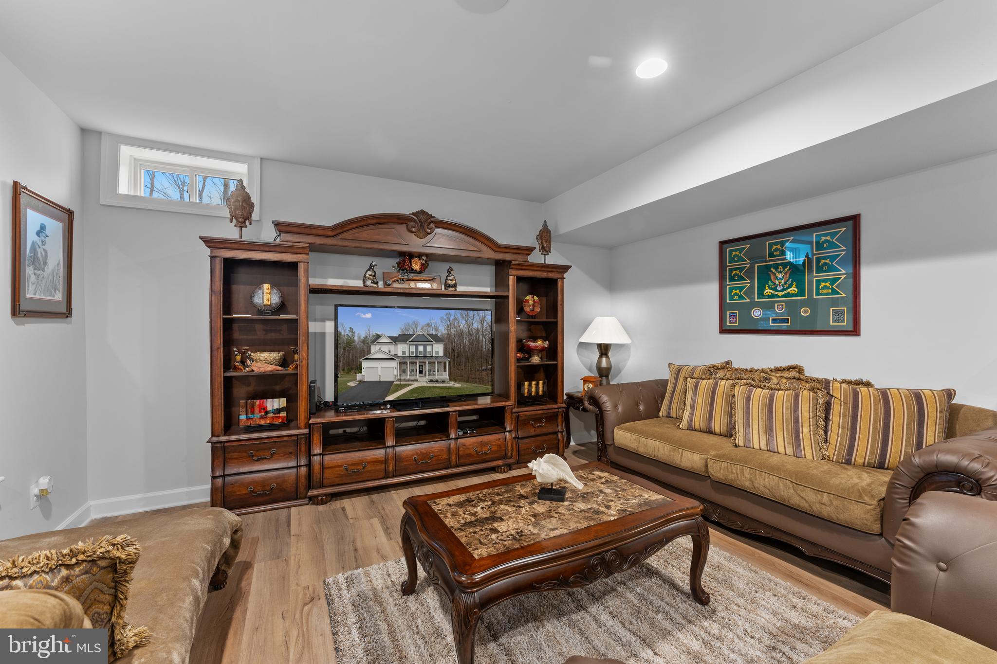13882 Trinity Pond Lane Manassas, VA 20112 - Photo 59 of 69 a living room with furniture a rug and a flat screen tv