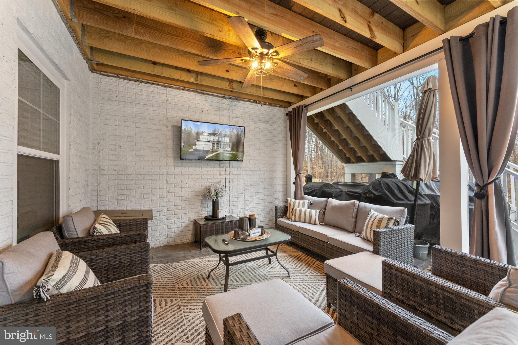 13882 Trinity Pond Lane Manassas, VA 20112 - Photo 63 of 69 a living room with furniture and a flat screen tv