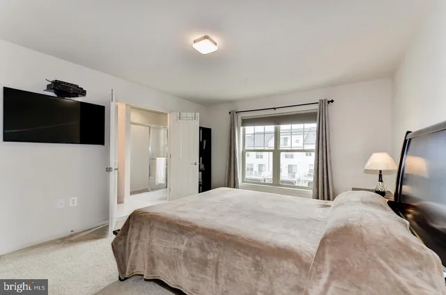 a bedroom with a bed and a television