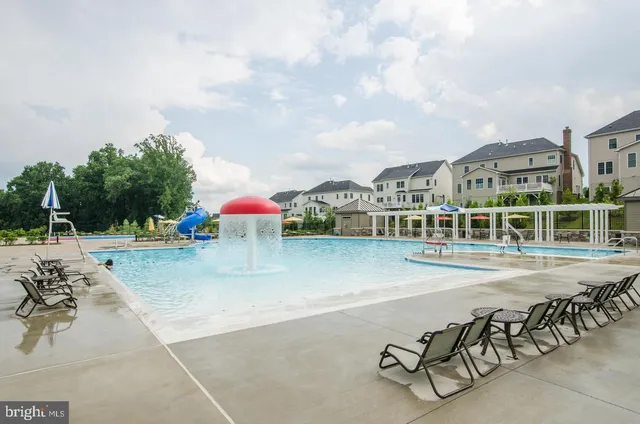 a view of a swimming pool with outdoor seating