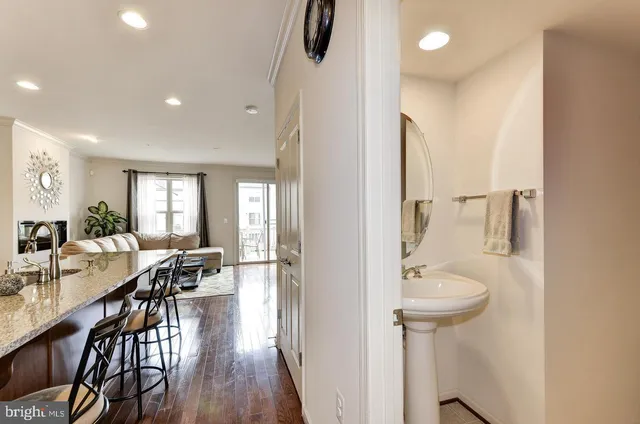 a view of a hallway with dining room and wooden floor