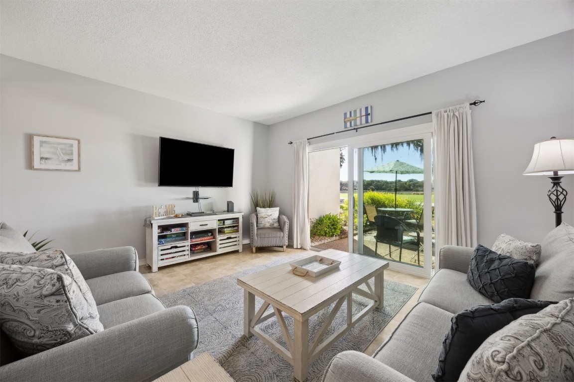 3012 Sea Marsh Road, Unit 3012 Fernandina Beach, FL 32034 - Photo 14 of 54 a living room with furniture and a flat screen tv