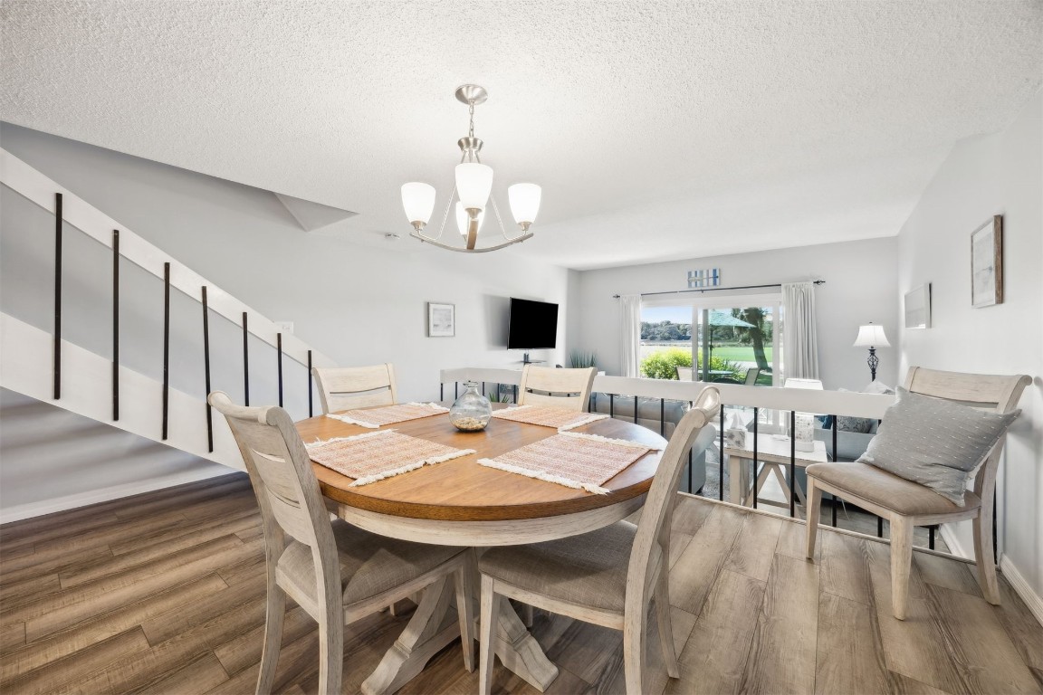 3012 Sea Marsh Road, Unit 3012 Fernandina Beach, FL 32034 - Photo 16 of 54 a view of a dining room with furniture and wooden floor