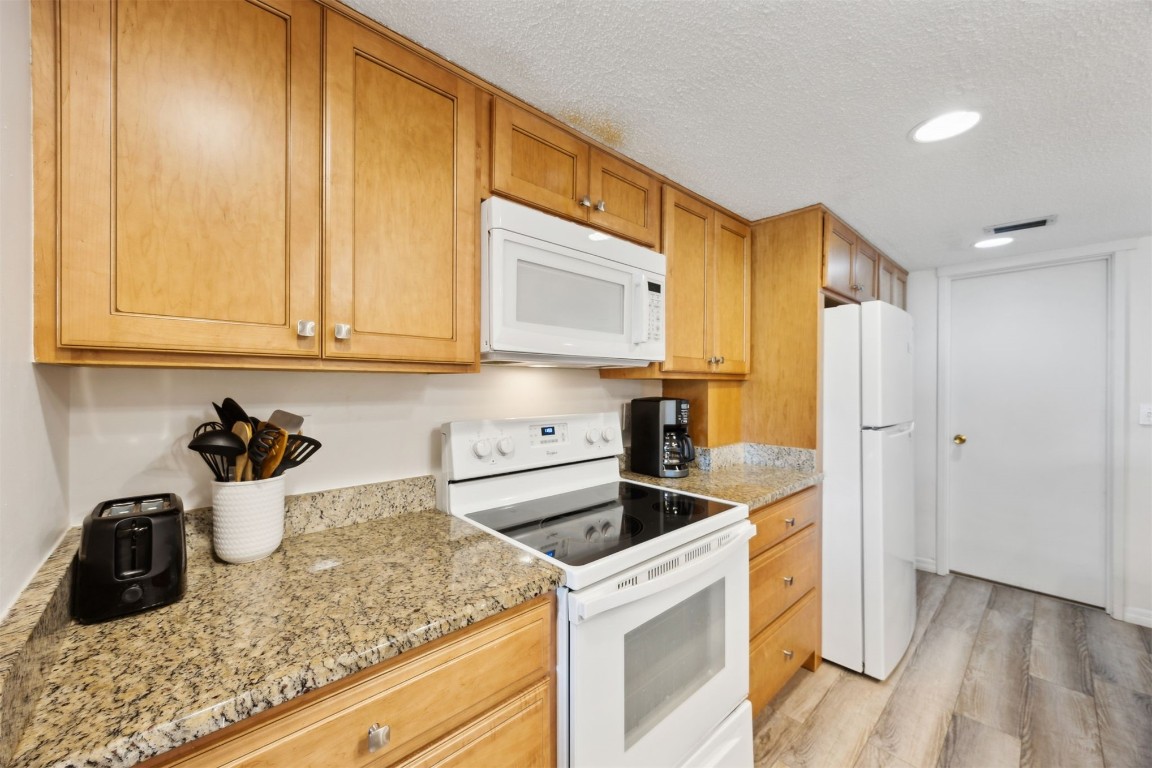 3012 Sea Marsh Road, Unit 3012 Fernandina Beach, FL 32034 - Photo 19 of 54 a kitchen with a sink a stove and cabinets