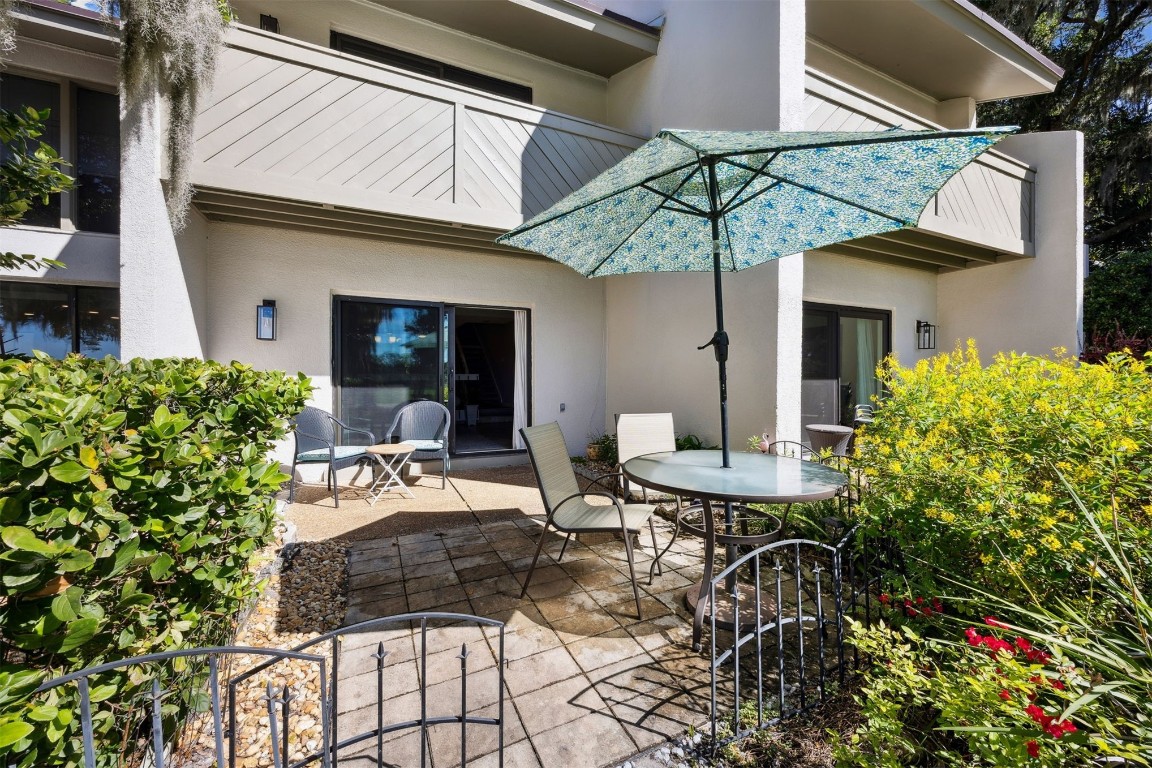 3012 Sea Marsh Road, Unit 3012 Fernandina Beach, FL 32034 - Photo 9 of 54 a view of a patio with table and chairs under an umbrella
