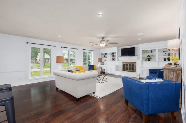a living room with furniture fireplace and flat screen tv