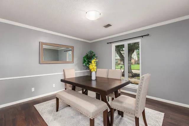 a view of a dining room with furniture and wooden floor