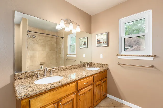a bathroom with a granite countertop sink a toilet and bathtub