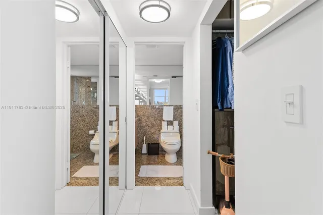 a kitchen with sink and a large mirror